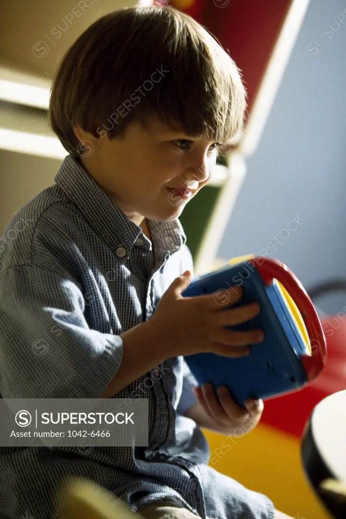 Close-up of a boy playing with a toy