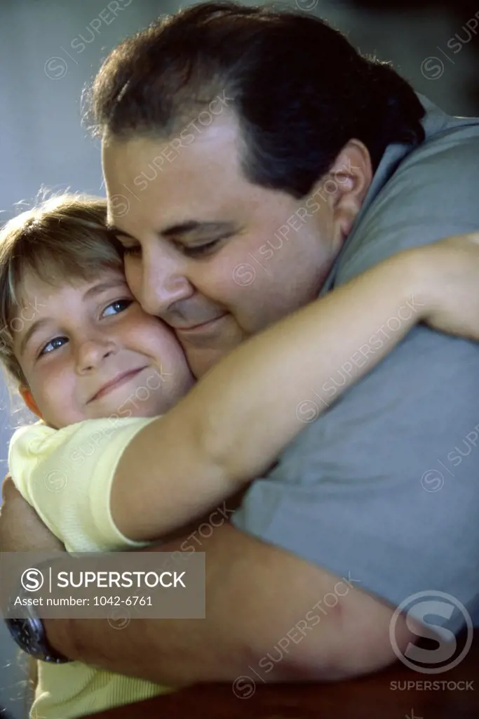 Close-up of a father hugging his daughter