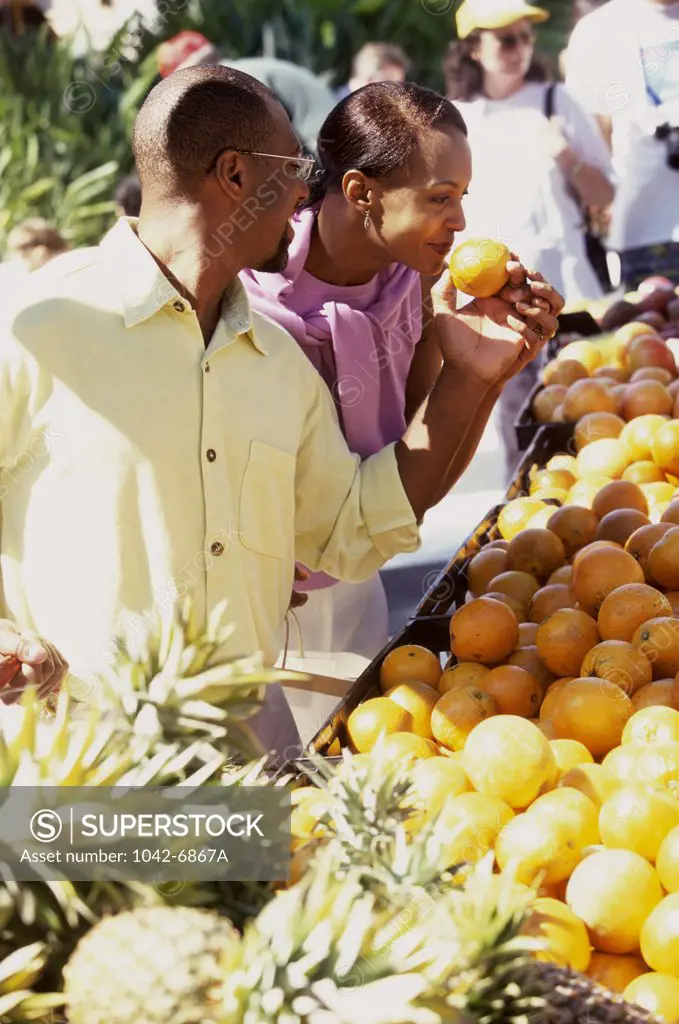 Mid adult couple choosing fruit