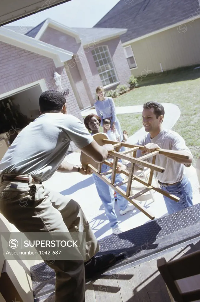 Group of people unloading furniture from a truck