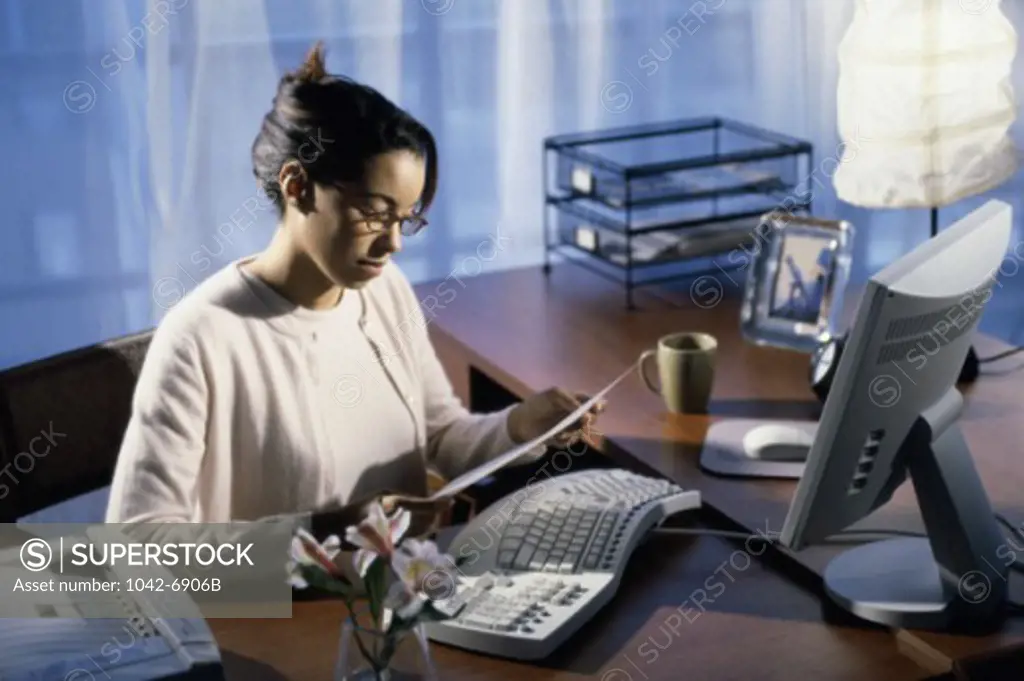 Side profile of a businesswoman reading a document