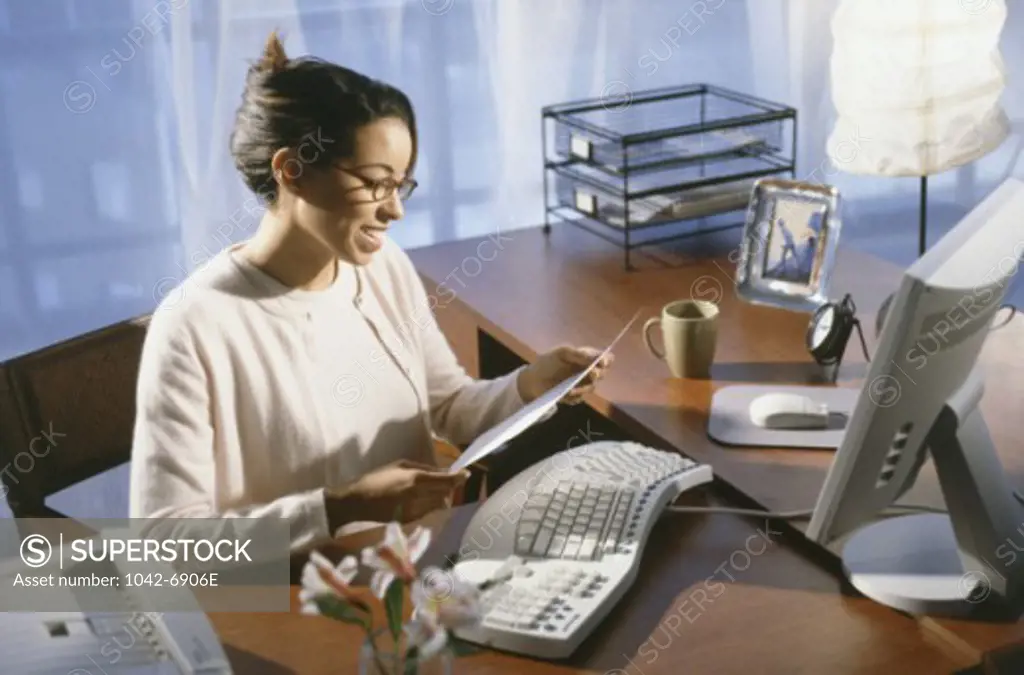 Side profile of a businesswoman reading a document
