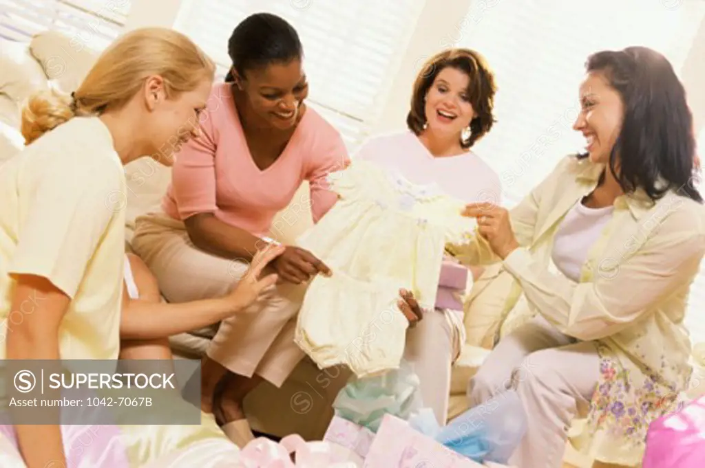 Young women opening presents at a baby shower