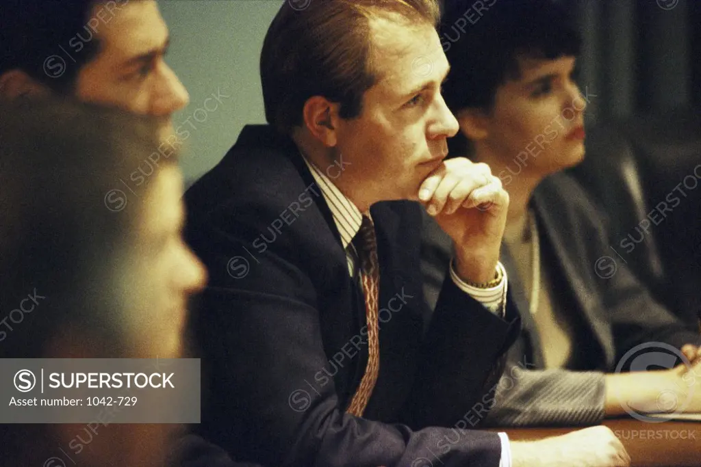 Side profile of a group of business executives in a meeting