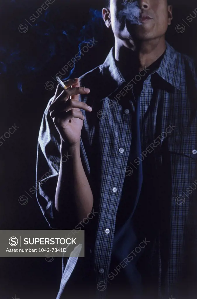 Teenage boy holding a cigarette