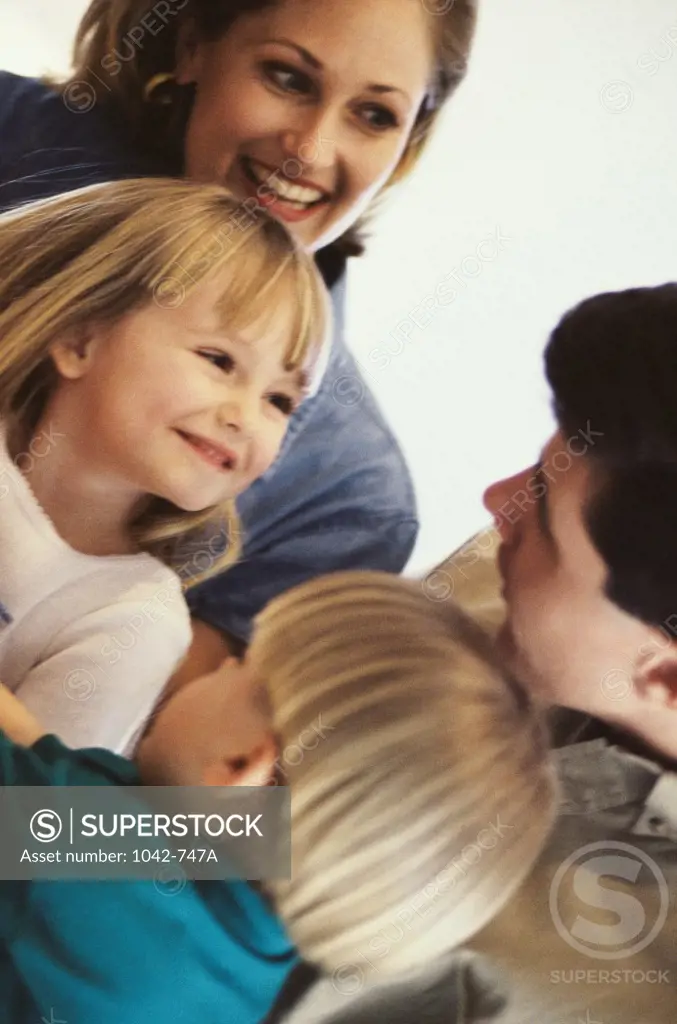 Mid adult couple with their children and smiling