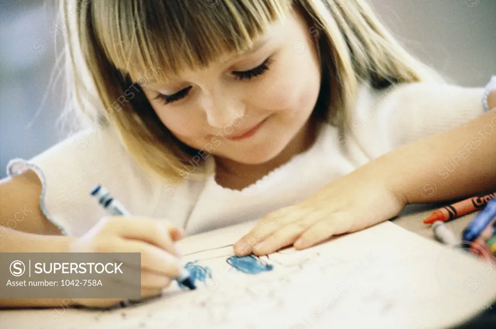 Girl drawing with crayons