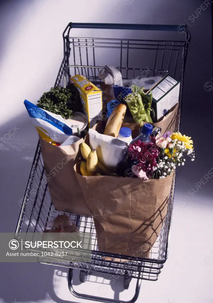 High angle view of shopping bags full of groceries in a shopping cart