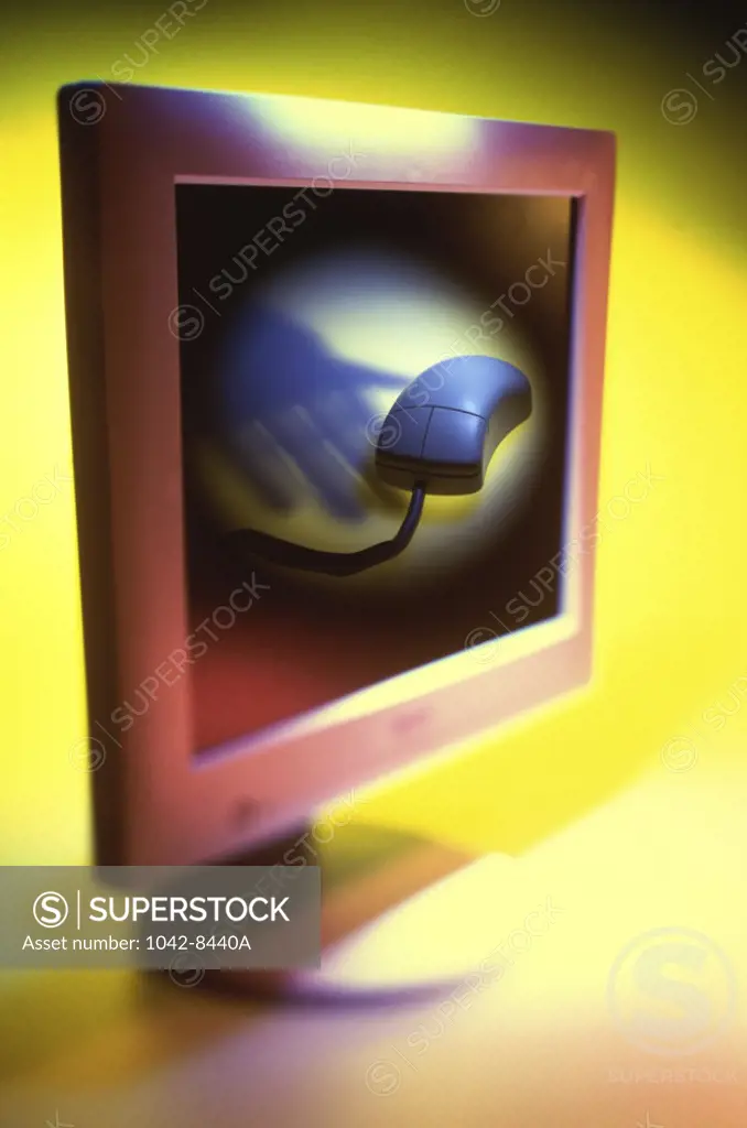 Close-up of a computer monitor with a computer mouse