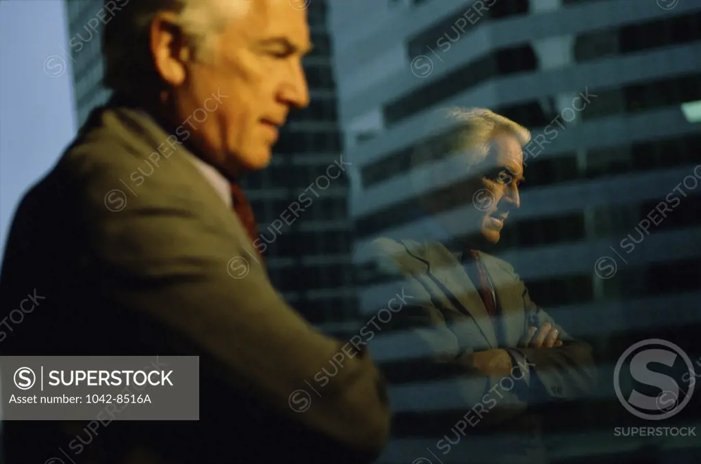 Side profile of a businessman looking through a window