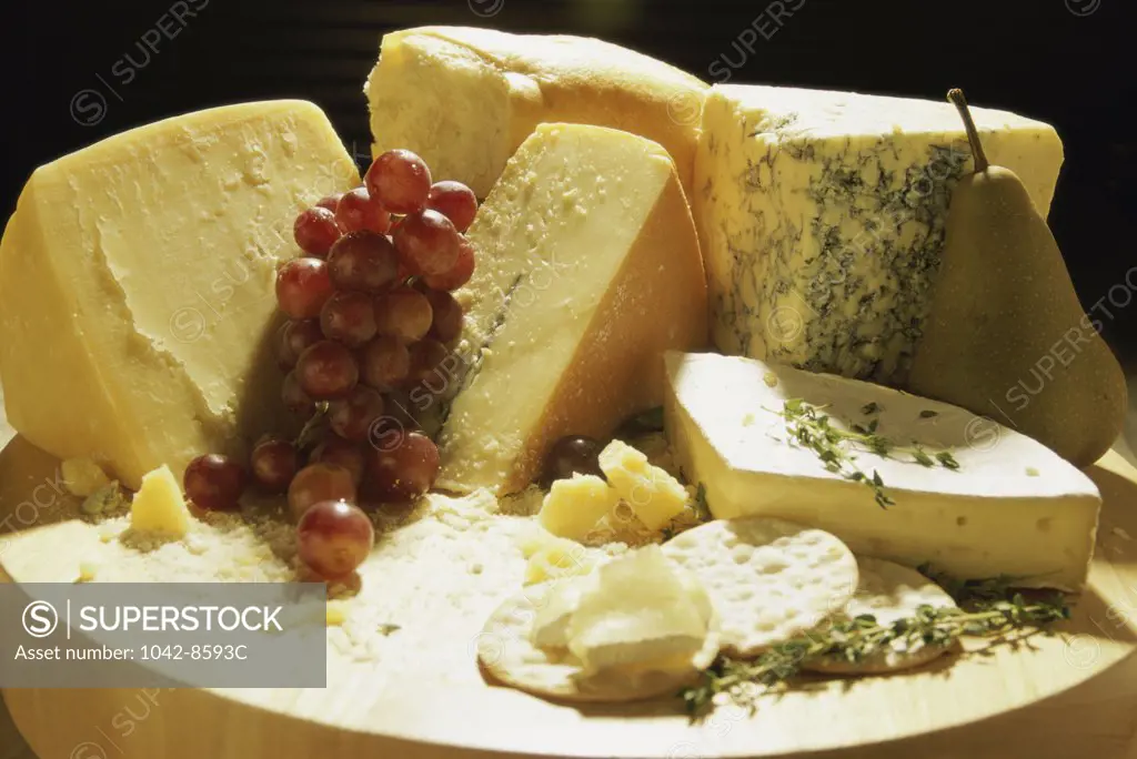 Close-up of grapes with assorted cheese