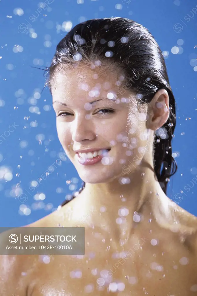 Young woman smiling taking a shower