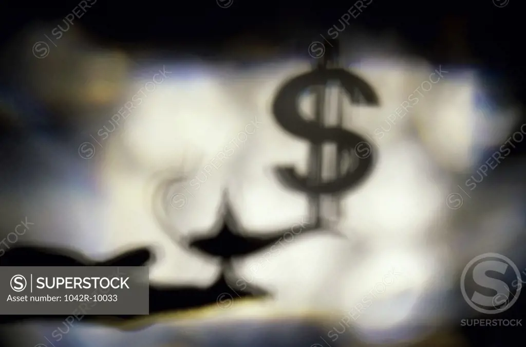 Silhouette of a magic lamp and a dollar sign