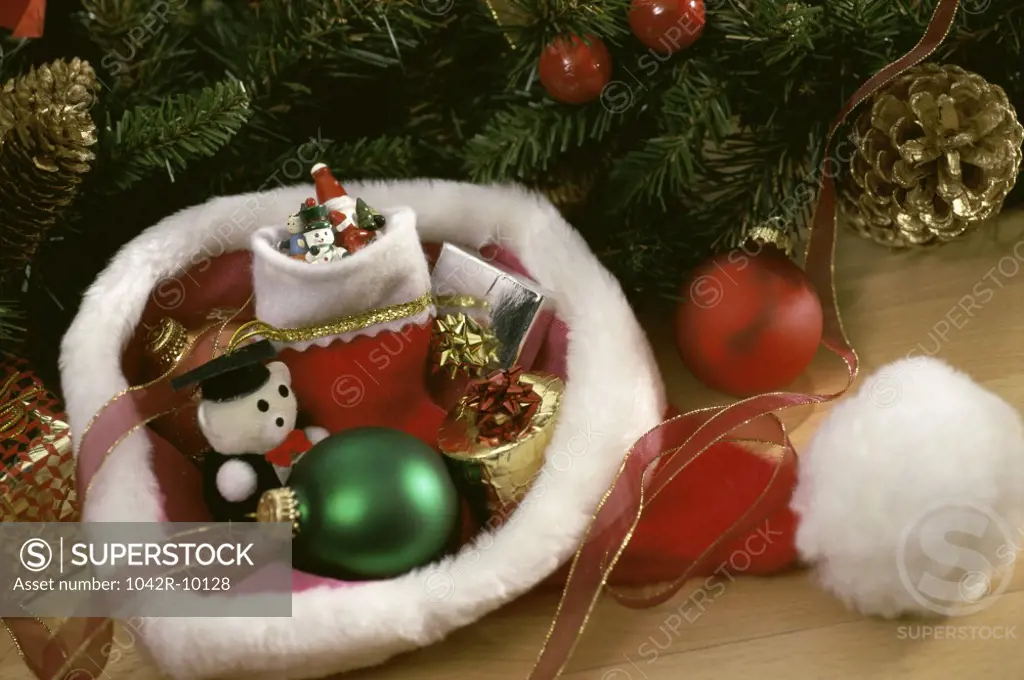 Christmas ornaments and gifts in a Santa hat