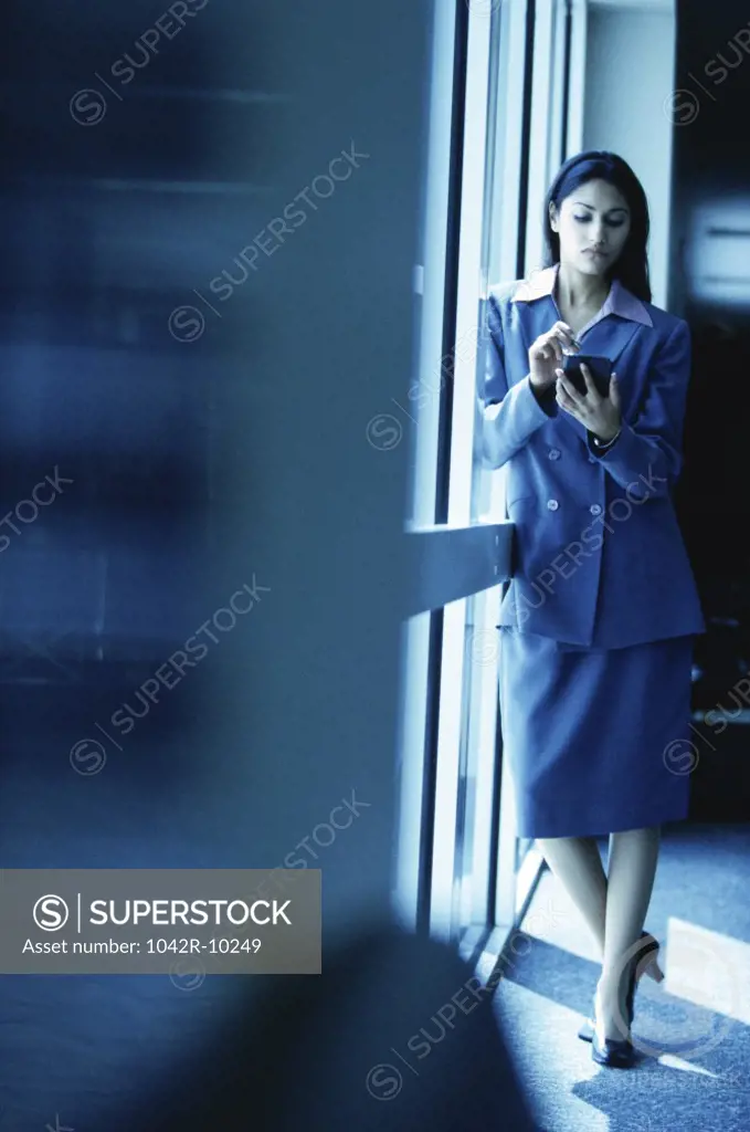 Businesswoman standing operating a hand held device