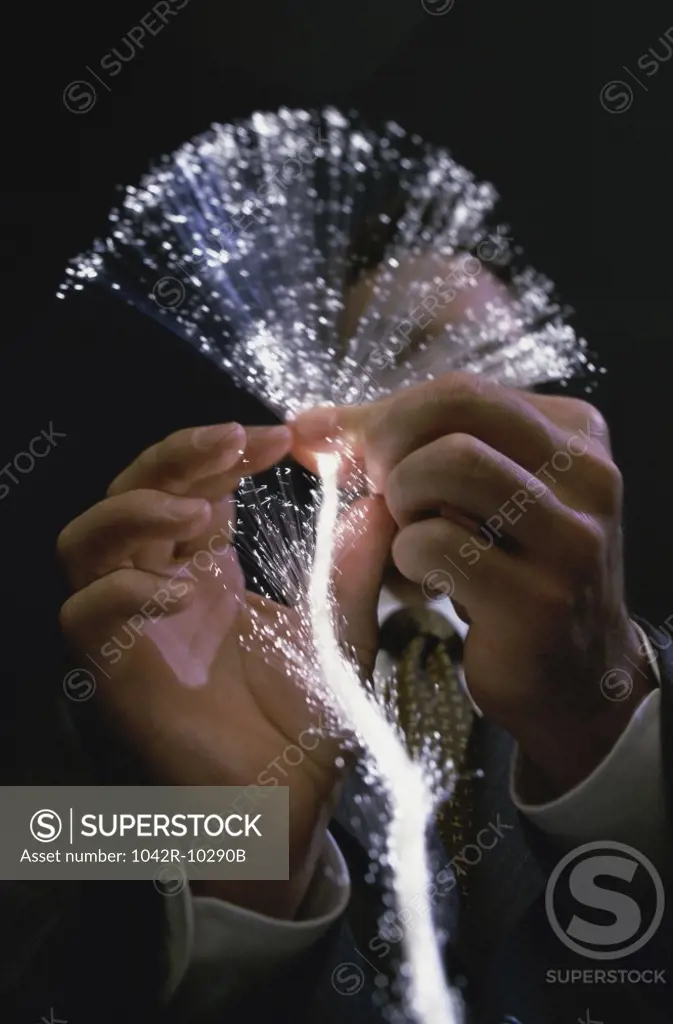 Close-up of a person holding fiber optic cables