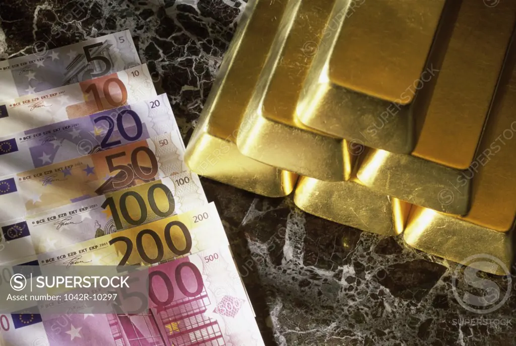 Gold bars next to euro banknotes