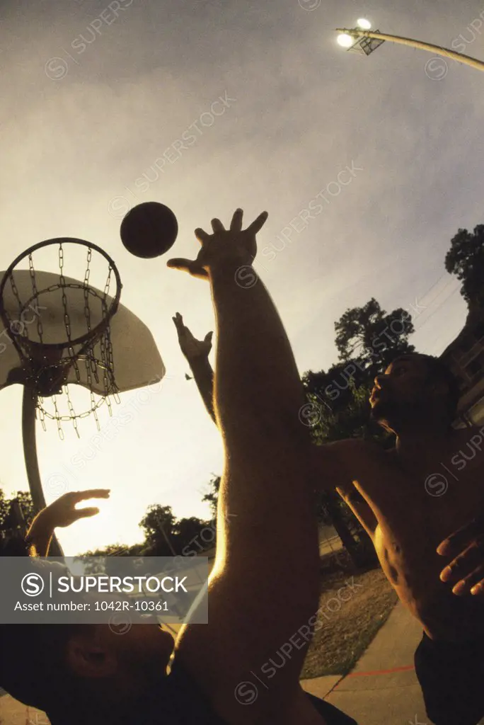 Young men playing basketball