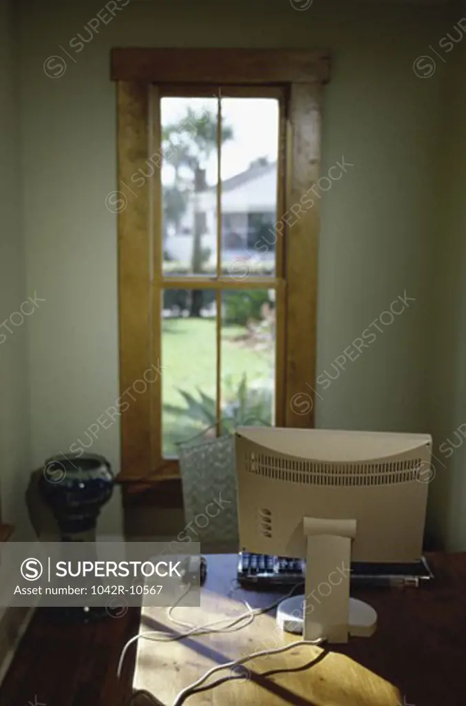 Computer monitor in front of a window