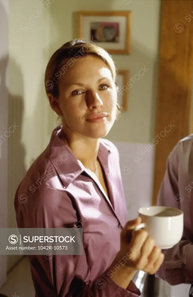 Portrait of a young woman holding a mug