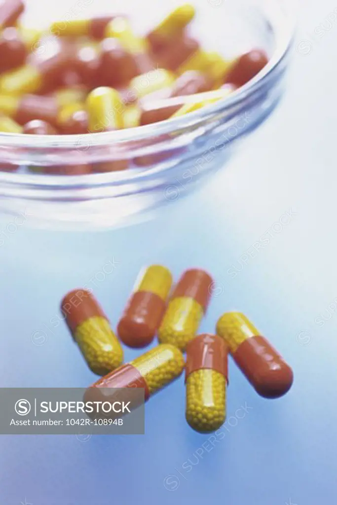 Close-up of capsules and a bowl