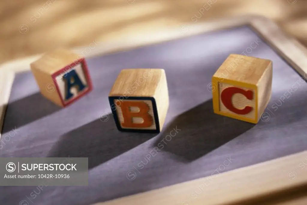 Wooden alphabet blocks on a chalkboard
