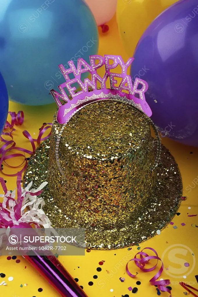 Sequined hat with a Happy New Year sign and streamers with balloons