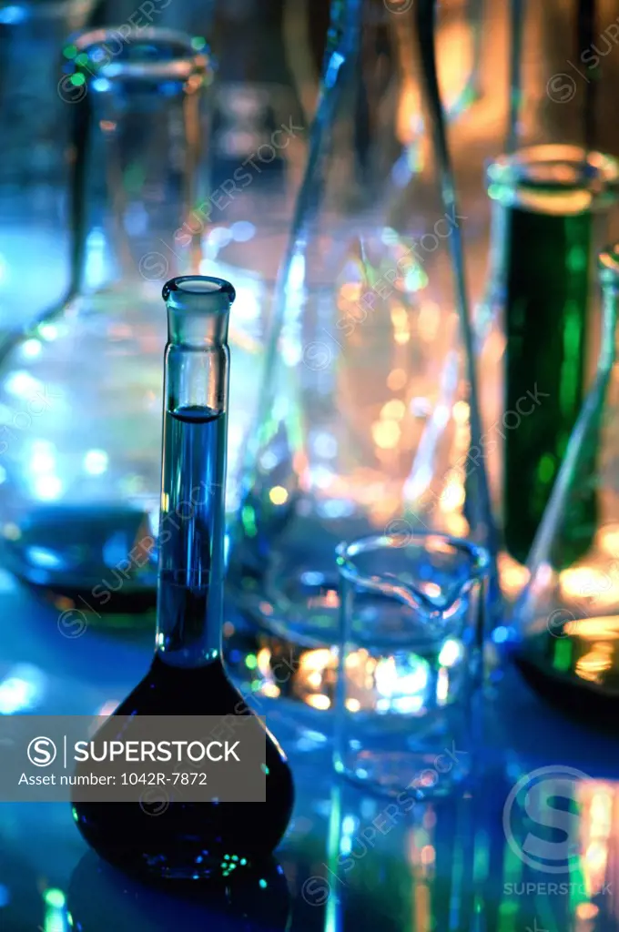 Close-up of beakers and graduated cylinders in a laboratory