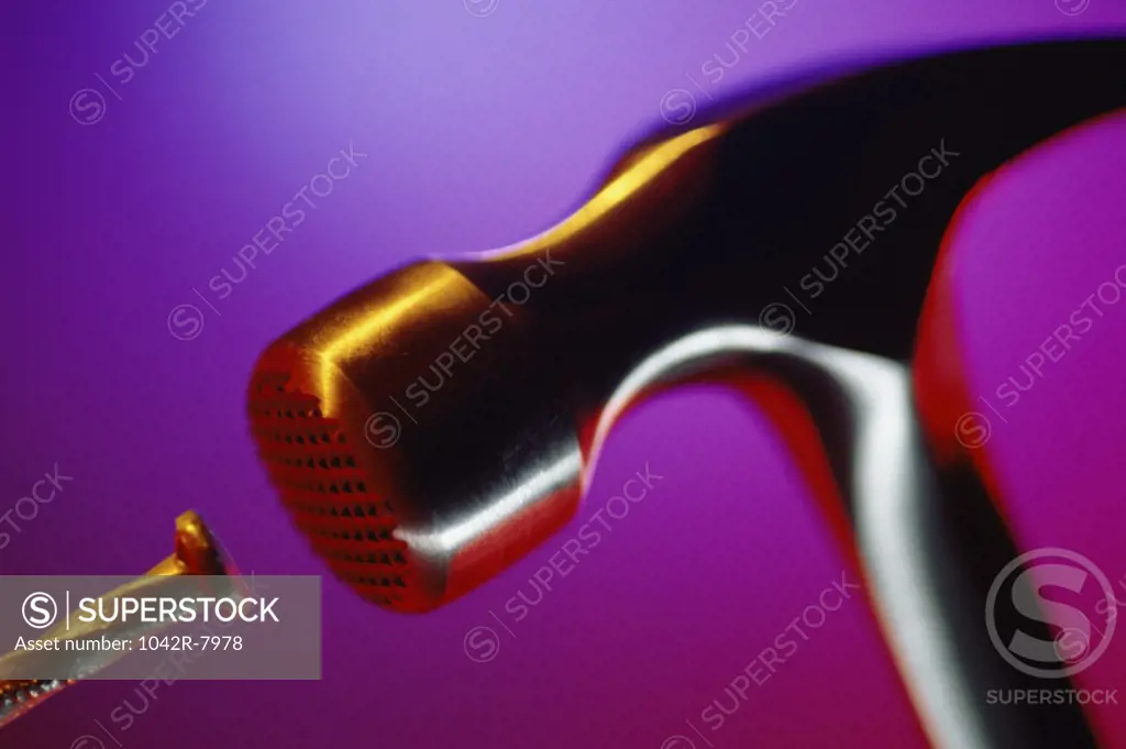 Close-up of a hammer hitting a nail