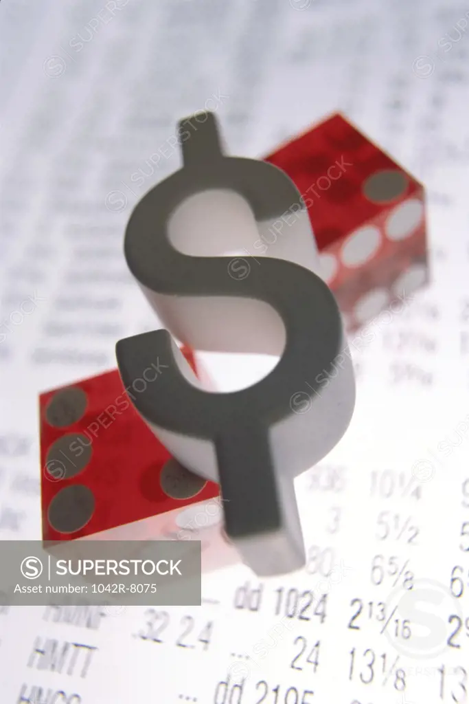 Dollar sign and a pair of dice on a financial report