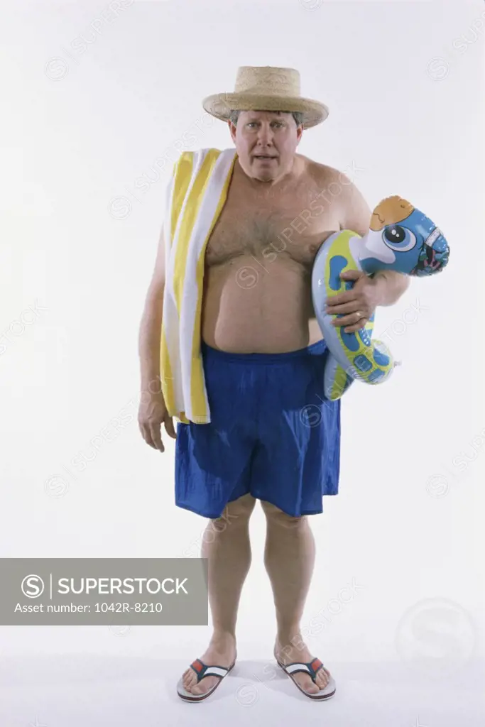 Portrait of a mid adult man holding an inflatable ring