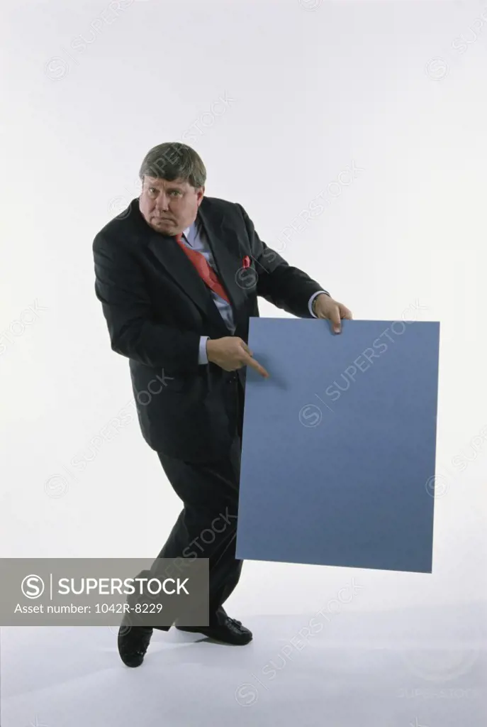 Portrait of a businessman holding a placard
