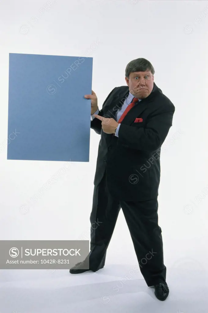Portrait of a businessman holding a placard
