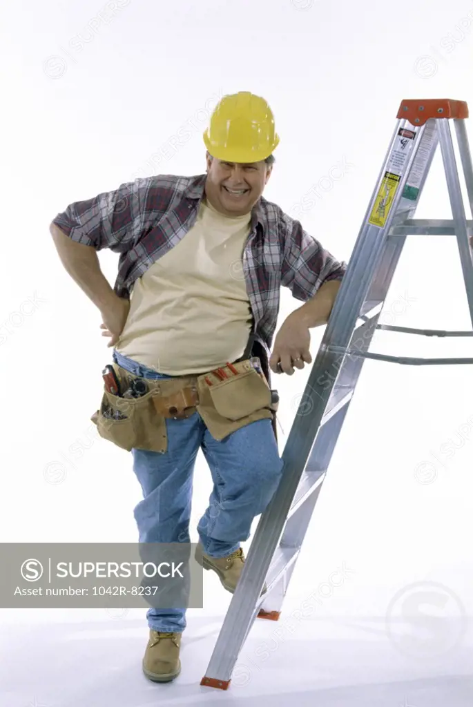 Portrait of a construction worker leaning against a ladder