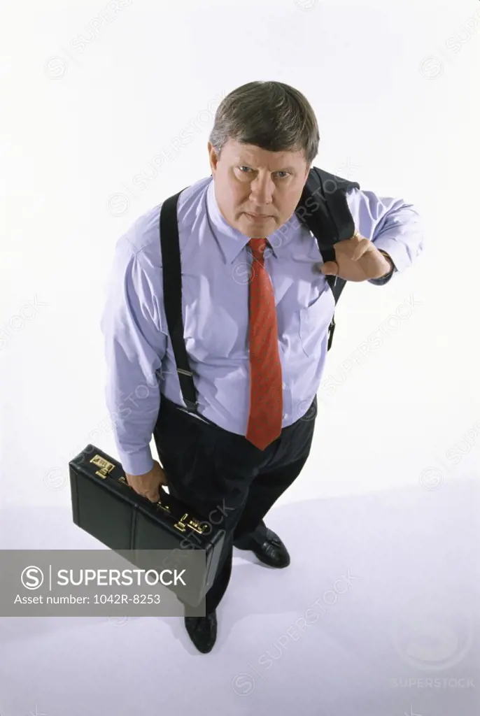 Portrait of a businessman holding a coat and a briefcase