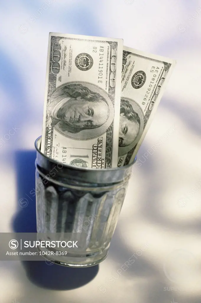 American dollar bills in a wastepaper basket