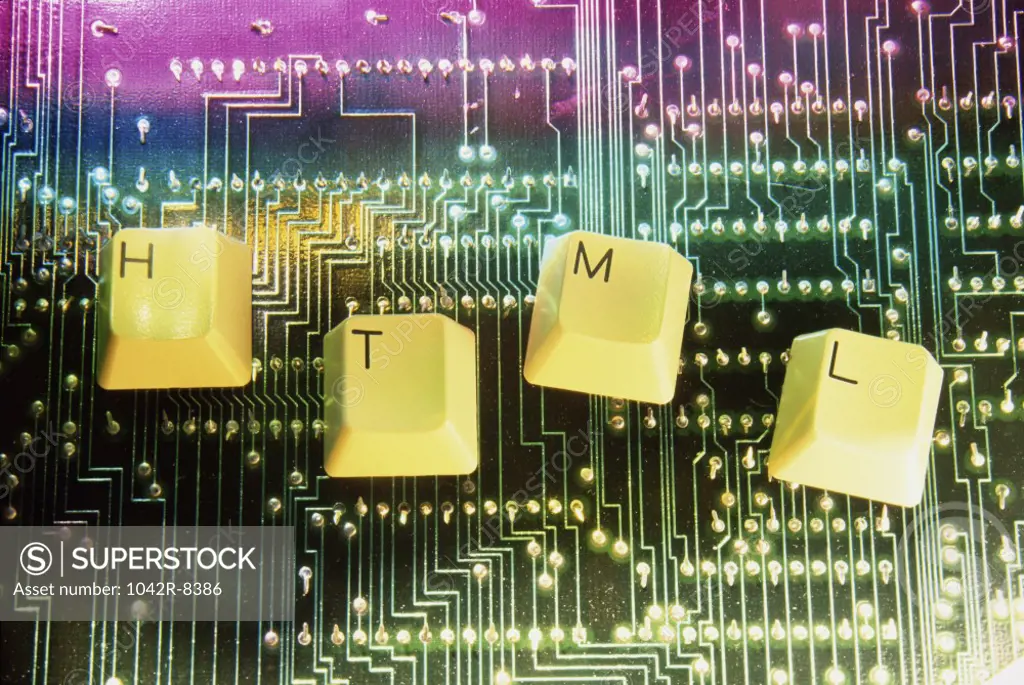 Close-up of key spelling HTML on a circuit board