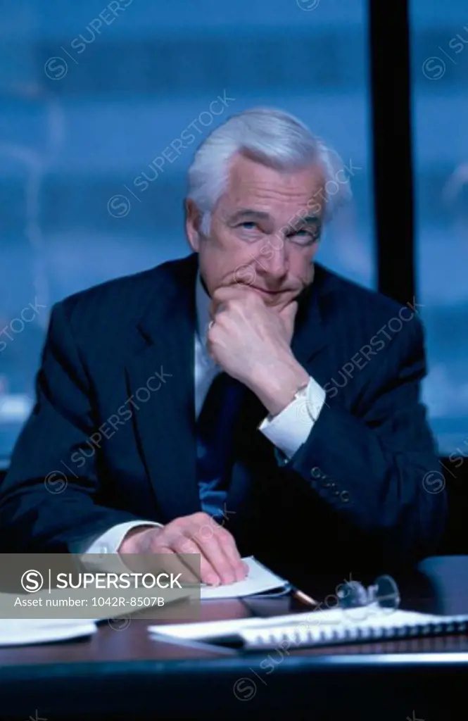 Portrait of senior businessman seated at an office desk