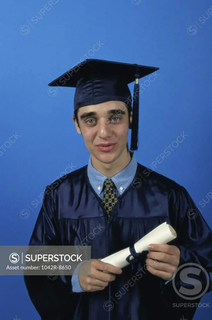 Portrait of a young male graduate holding a diploma