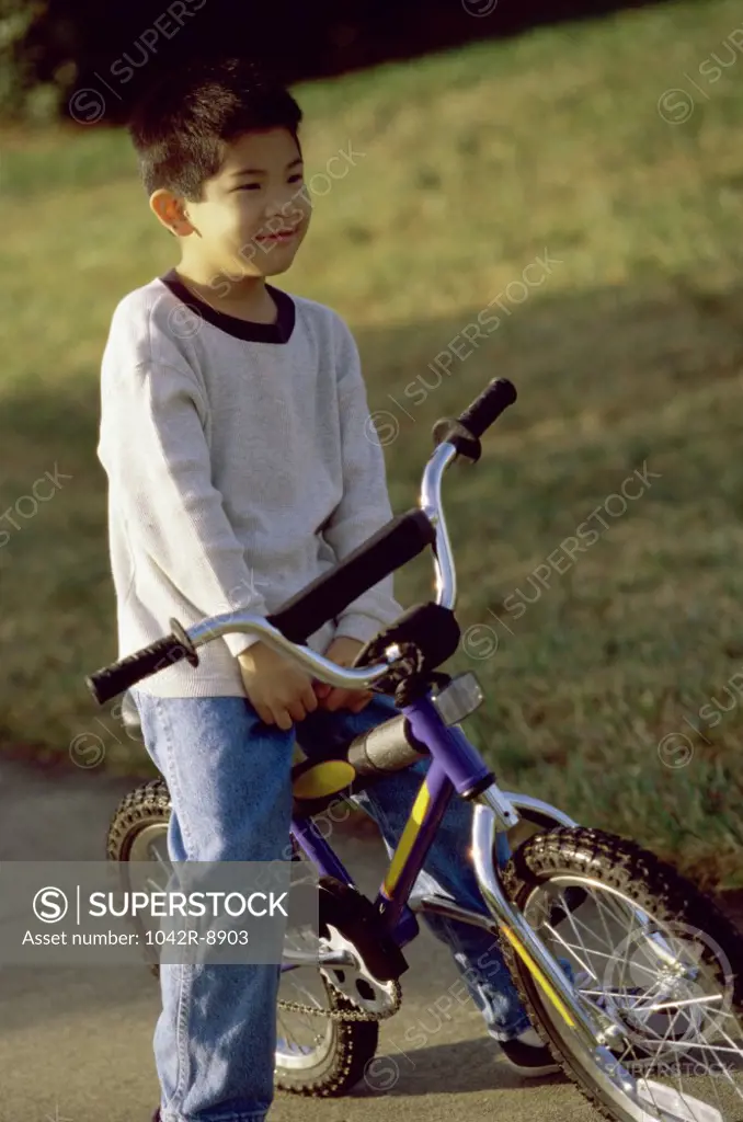 Boy sitting on a bicycle