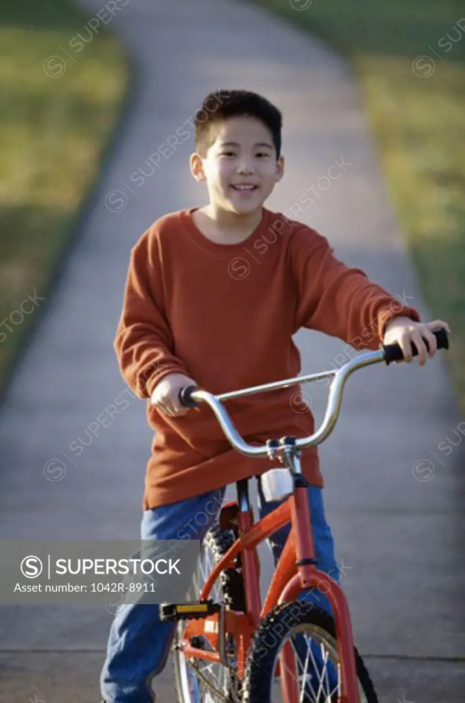 Portrait of a boy sitting on a bicycle