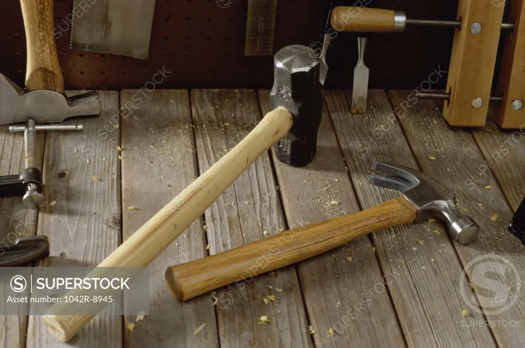 Close-up of a sledge hammer and a claw hammer