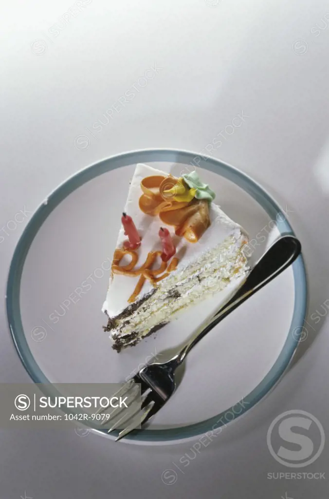 Slice of cake and a fork on a plate