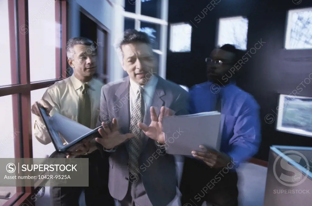 Three businessmen discussing in an office