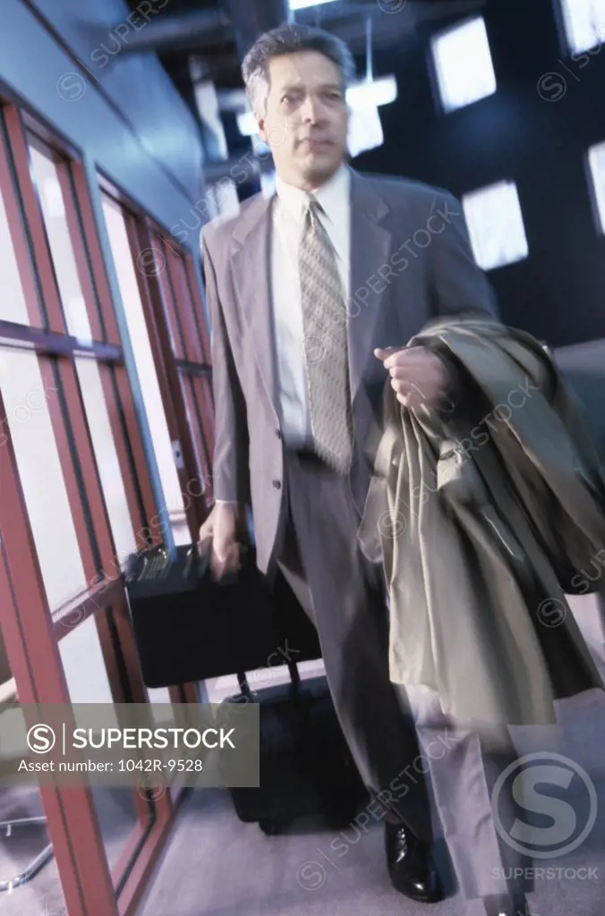 Businessman pulling his luggage