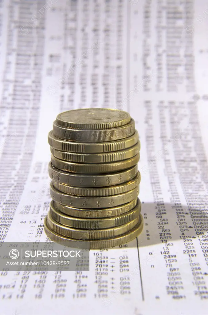 Close-up of a stack of coins on financial figures