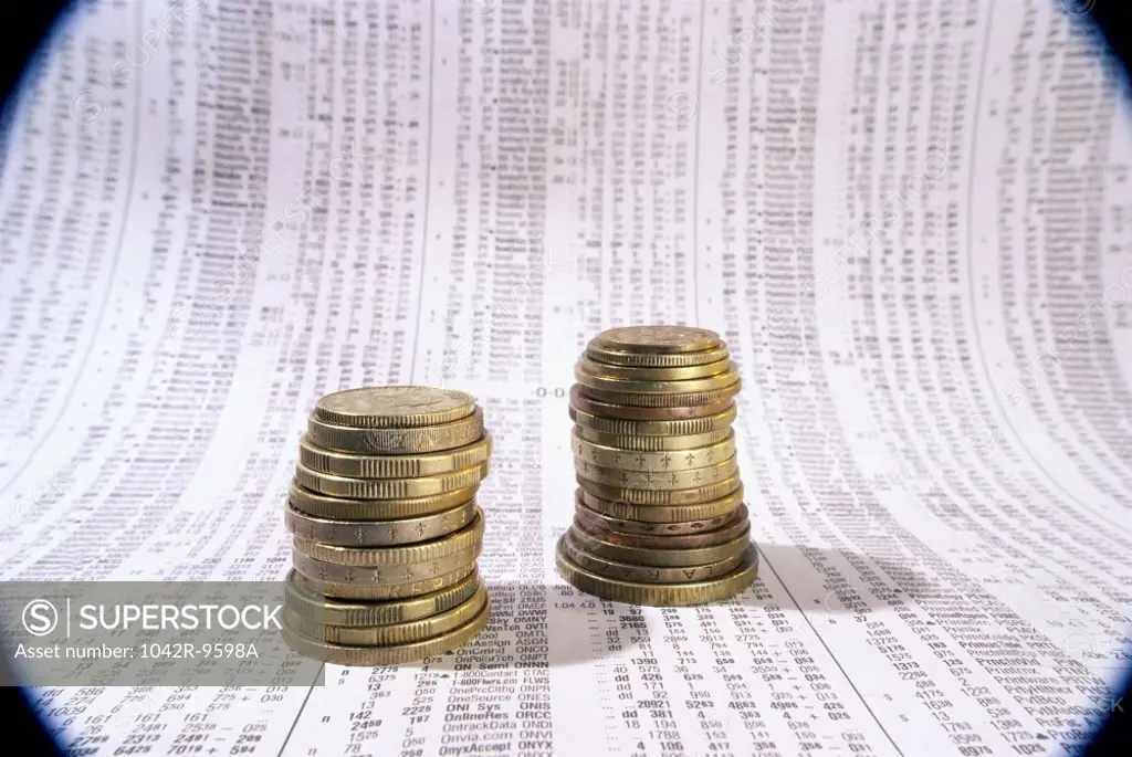 Close-up of a stack of coins on financial figures
