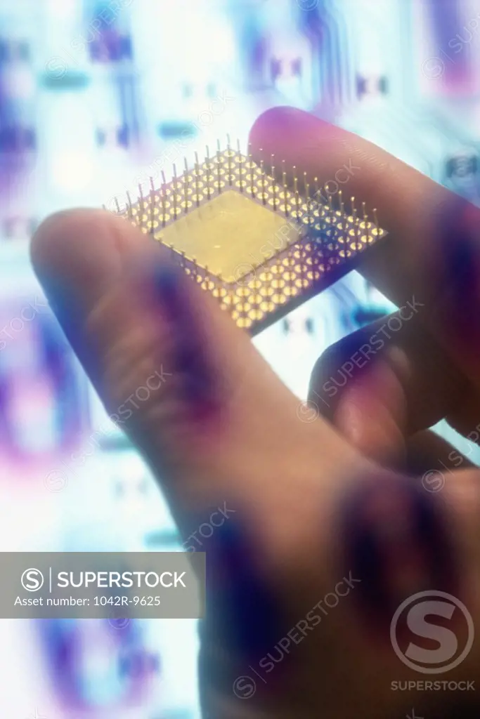 Binary code superimposed over a person's hand holding a computer chip
