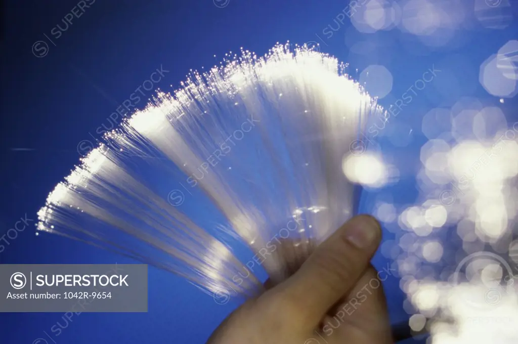 Close-up of a person holding fiber optic cables