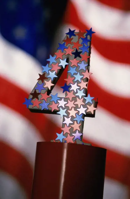 Number four covered with stars and the American flag in the background
